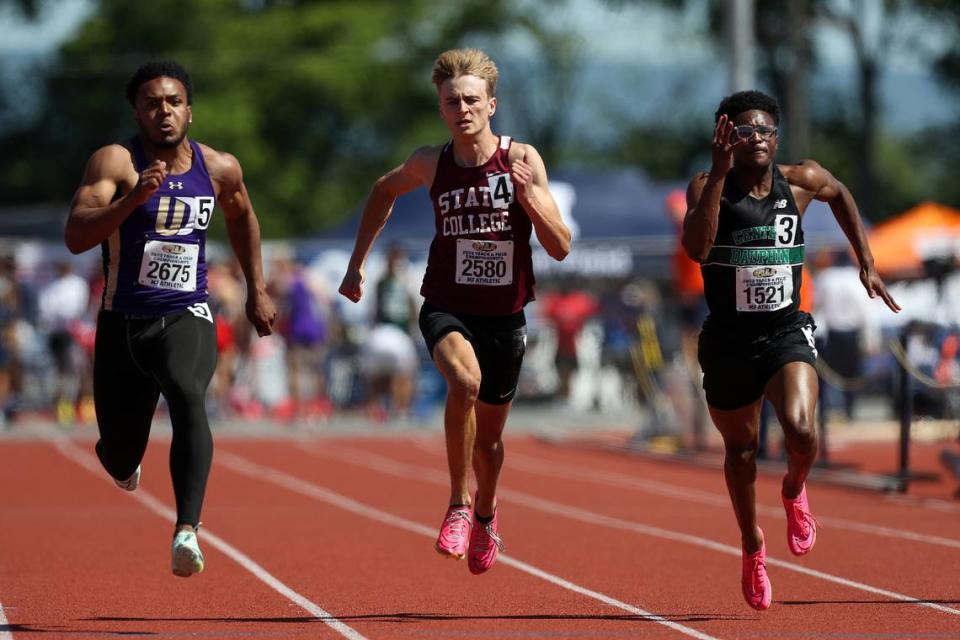 State College’s Jesse Myers, center, competes in the 100 meter dash preliminaries during the PIAA Track and Field Championships held Friday at Seth Grove Stadium at Shippensburg University.