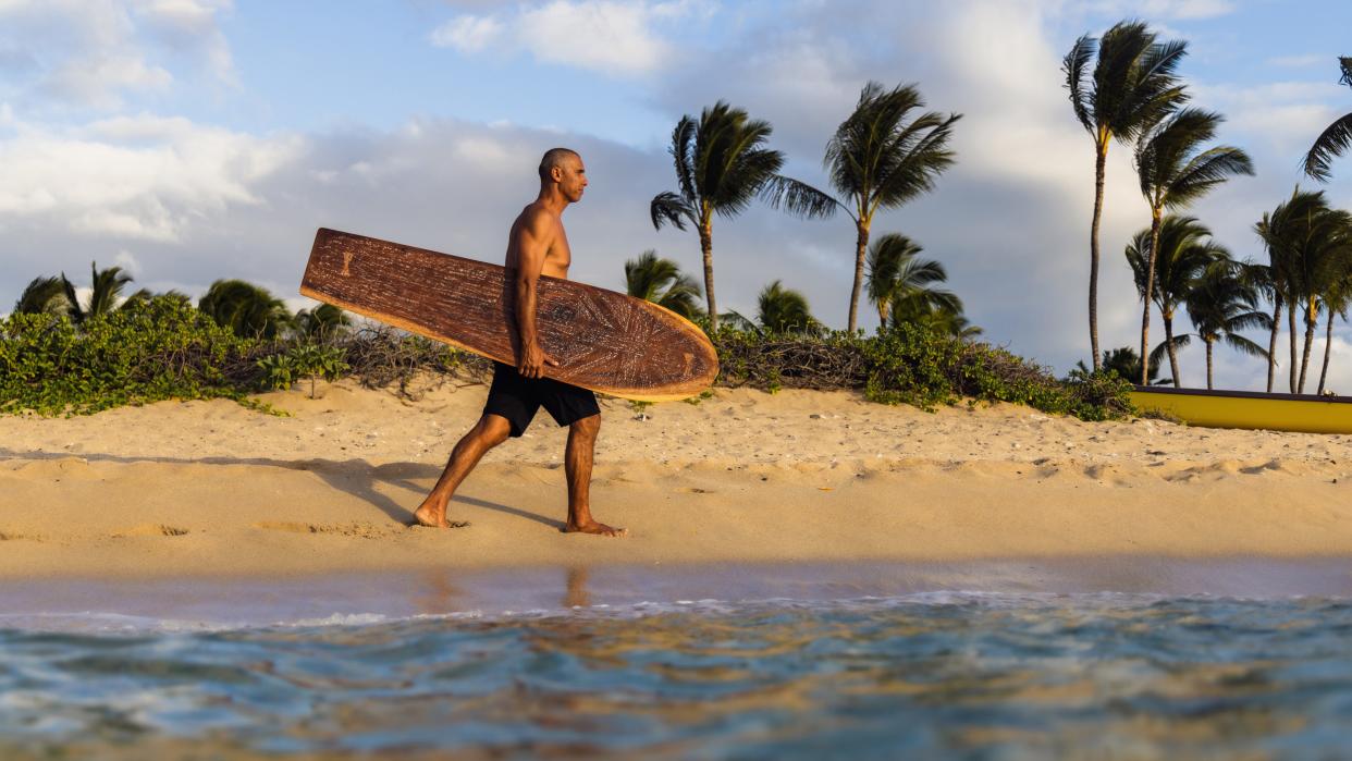 Bonga Perkins finds beauty in bringing the original boards down to the break, the way his ancestors did.