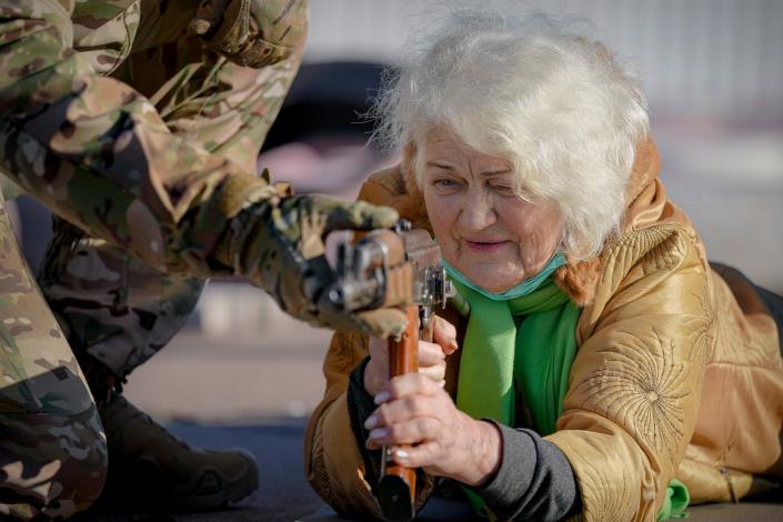 Valentyna Konstantynovska, 79, holds a weapon during basic combat training for civilians on Sunday, which was organized by the Special Forces Unit Azov, of Ukraine&#39;s National Guard, in Mariupol, Donetsk region, eastern Ukraine. The United States is evacuating almost all staff from its embassy in Kyiv as Western intelligence officials warn that a Russian invasion of Ukraine is increasingly imminent.