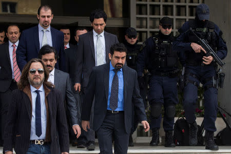 The eight Turkish soldiers, who fled to Greece in a helicopter and requested political asylum after a failed military coup against the government, are escorted by police officers as they leave the Supreme Court in Athens, Greece, January 23, 2017. REUTERS/Alkis Konstantinidis