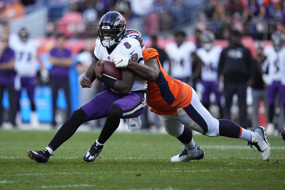 Baltimore Ravens quarterback Lamar Jackson (8) is sacked by Denver Broncos defensive end Shelby Harris during the second half of an NFL football game, Sunday, Oct. 3, 2021, in Denver. (AP Photo/Jack Dempsey)