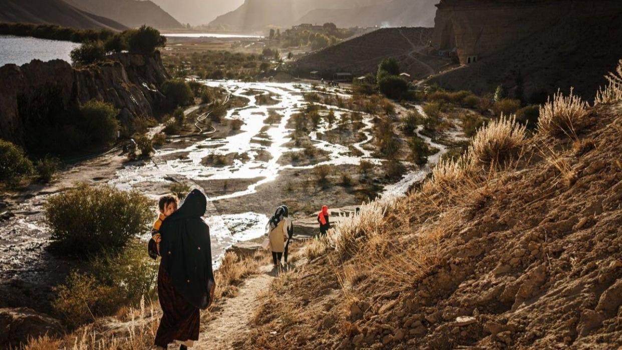 Visitors walk through Band-e Amir National Park, a popular tourist attraction in Bamyan province near Yakawlang, Afghanistan, September 2022.