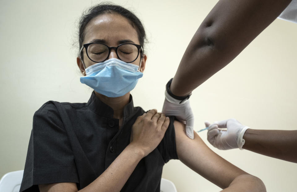 A member of hospital staff receives some of the country's first coronavirus vaccinations using AstraZeneca COVID-19 vaccine manufactured by the Serum Institute of India and provided through the global COVAX initiative, at Kenyatta National Hospital in Nairobi, Kenya Friday, March 5, 2021. Urgent calls for COVID-19 vaccine fairness rang through African countries on Friday as more welcomed or rolled out doses from the global COVAX initiative, with officials acutely aware their continent needs much more. (AP Photo/Ben Curtis)