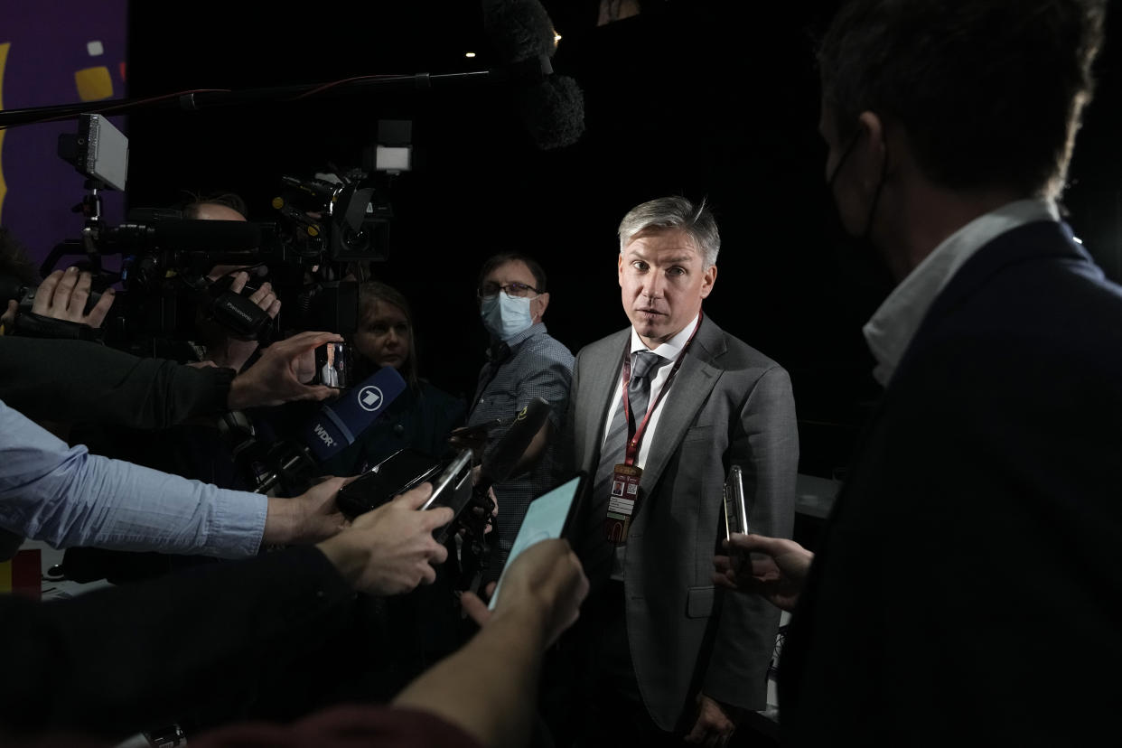 Russia delegate Alexey Sorokin, right, speaks to journalists end of the FIFA congress at the Doha Exhibition and Convention Center in Doha, Qatar, Thursday, March 31, 2022. (AP Photo/Hassan Ammar)