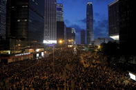 In this Sunday, June 16, 2019, photo, protesters wearing black t-shirts gather on a main road near the Legislative Council as they continuing protest against the unpopular extradition bill in Hong Kong. The largely youth-driven movement challenging Hong Kong's government over an unpopular extradition law is a coalition operating without a clear leadership structure. And that adds to its appeal for supporters disaffected from the moneyed elites who run the former British colony, organizers say. (AP Photo/Kin Cheung)