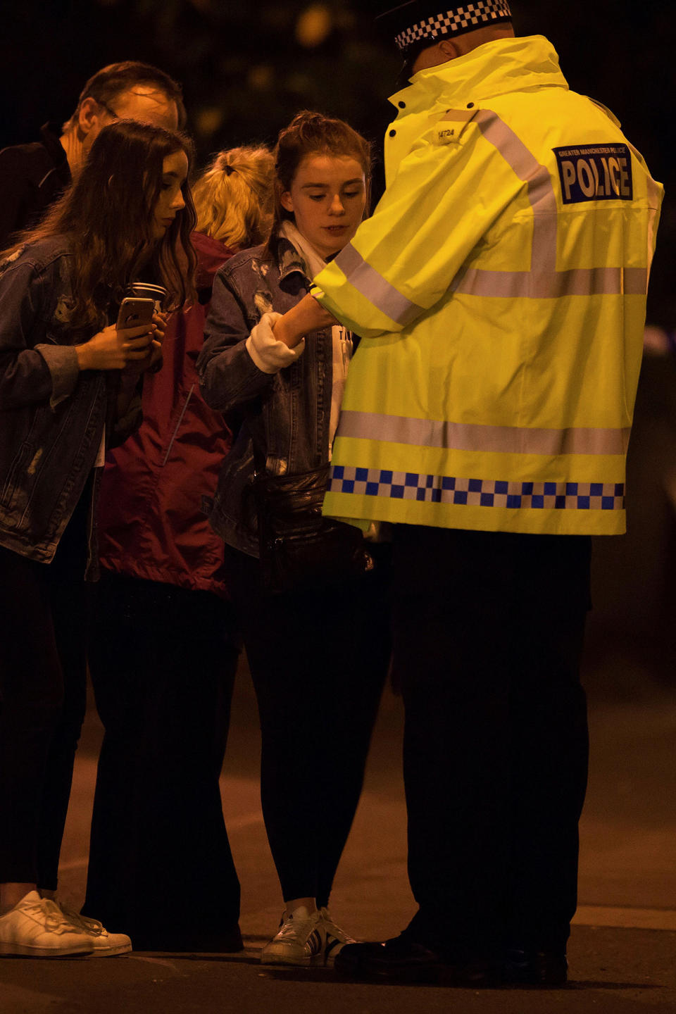 <p>A police officer talks to locals outside the Manchester Arena, where U.S. singer Ariana Grande had been performing, in Manchester, northern England, Britain May 22, 2017. (Jon Super/Reuters) </p>