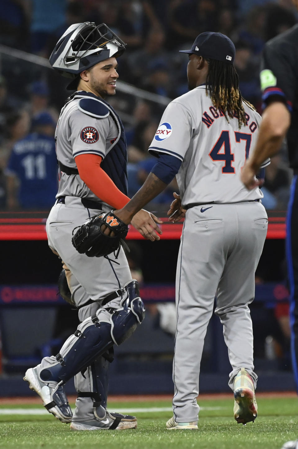 Houston Astros' Yainer Diaz, left, and relief pitcher Rafael Montero celebrate their team's victory over the Toronto Blue Jays after a baseball game in Toronto on Wednesday, July 3, 2024. (Jon Blacker/The Canadian Press via AP)