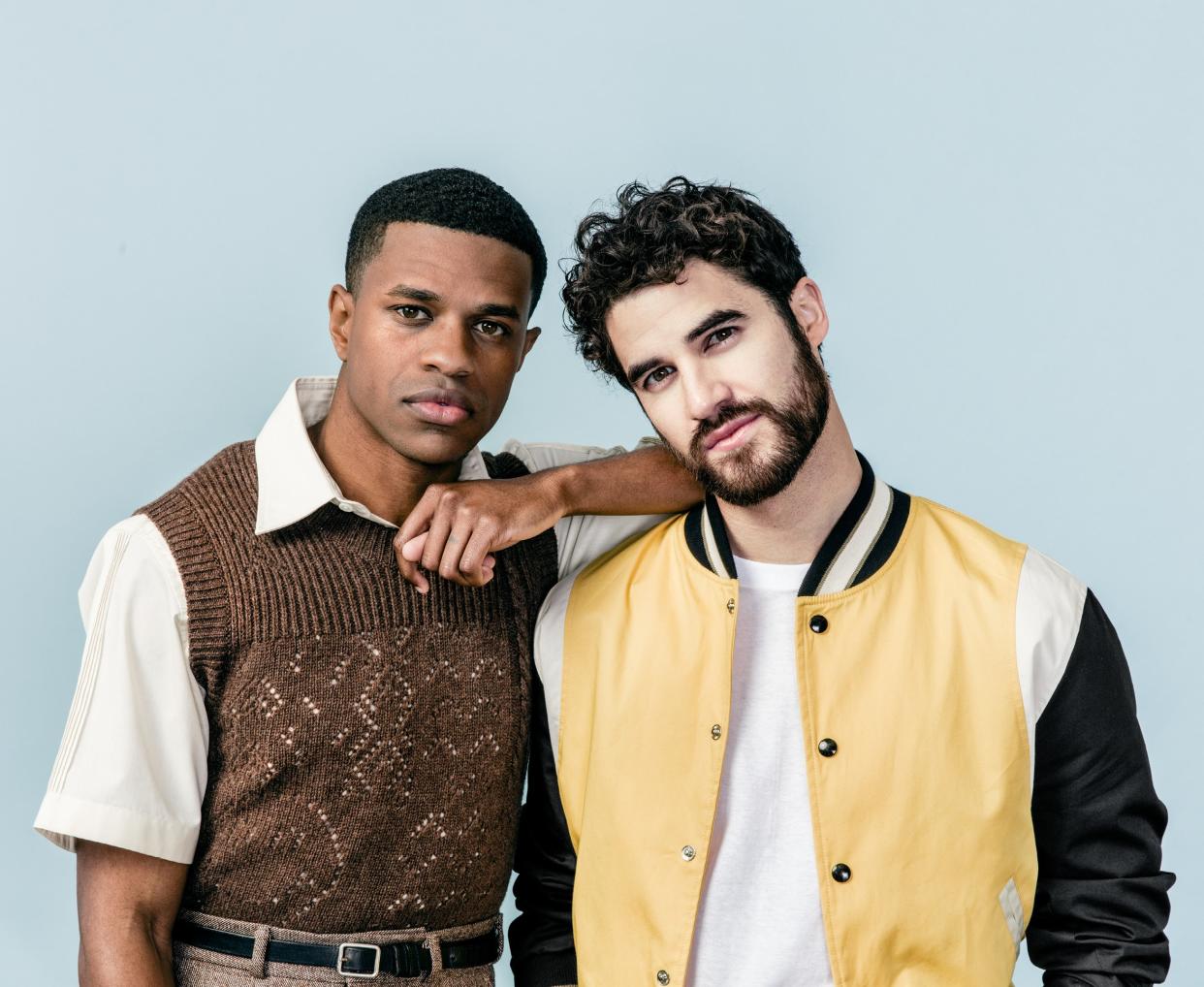 Jeremy Pope (left, in a Raf Simons vest and David Hart shirt) and Darren Criss (in a Golden Bear jacket). Menswear editor: Michael Philouze. Grooming, Frederic Boudet and Jessica Ortiz. Produced by William Galusha.