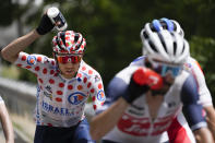 Michael Woods of Canada, wearing the best climber's dotted jersey, cools off during the fifteenth stage of the Tour de France cycling race over 191.3 kilometers (118.9 miles) with start in Ceret and finish in Andorra-la-Vella, Andorra, Sunday, July 11, 2021. (AP Photo/Daniel Cole)