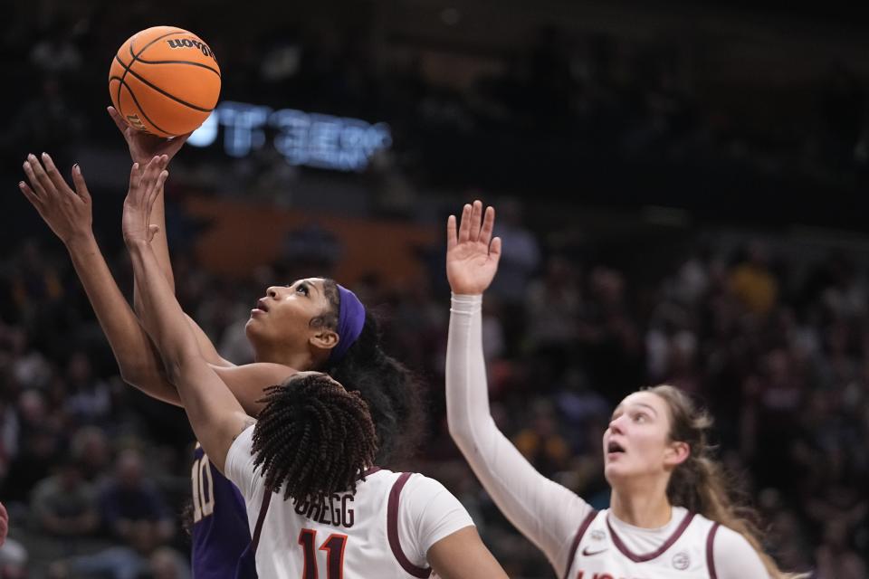 LSU's Angel Reese tries to shoot past Virginia Tech's D'asia Gregg and Elizabeth Kitley during the second half of an NCAA Women's Final Four semifinals basketball game Friday, March 31, 2023, in Dallas. (AP Photo/Darron Cummings)