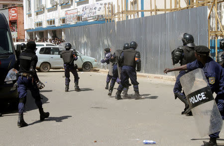 Riot police hold their position as they attempt to disperse supporters of Democratic Republic of Congo's opposition Presidential candidate Moise Katumbi as they escort him to the prosecutor's office over government allegations he hired mercenaries in a plot against the state, in Lubumbashi, the capital of Katanga province, May 13, 2016. REUTERS/Kenny Katombe