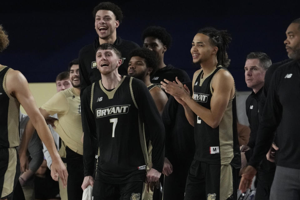 Bryant University forward Connor Withers (7) and his teammates cheer the team during the second half of an NCAA college basketball game against Florida Atlantic, Saturday, Nov. 18, 2023, in Boca Raton, Fla. (AP Photo/Marta Lavandier)