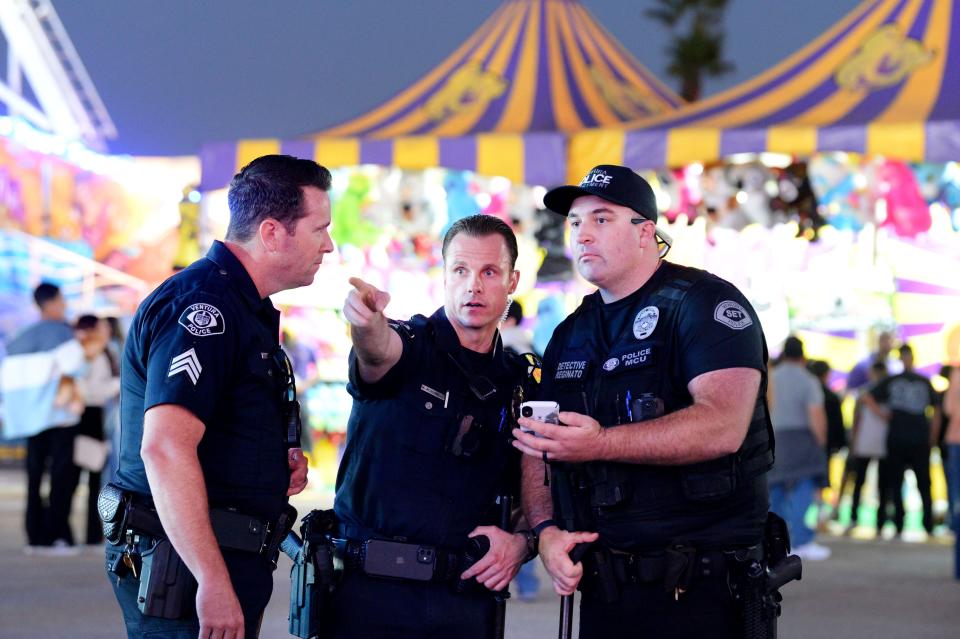 Ventura Police Department Sgt. Tim Ferrill, from left, Sgt. Mike Acquarelli and Detective Anthony Reginato point out some of the people involved in a fight at the Ventura County Fair on Friday.