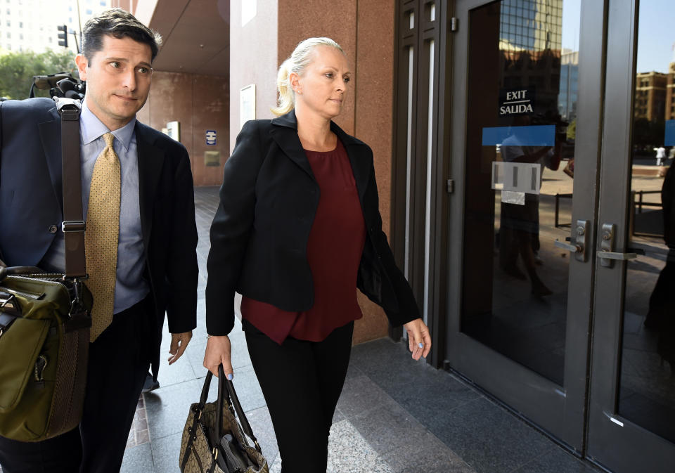 Margaret Hunter, right, the wife of U.S. Rep. Duncan Hunter, arrives for an arraignment hearing Thursday, Aug. 23, 2018, in San Diego. Hunter and his wife were indicted this week on federal charges that they used more than $250,000 in campaign funds for personal expenses that ranged from groceries to golf trips and lied about it in federal filings, prosecutors said. (AP Photo/Denis Poroy)