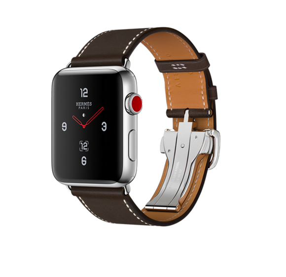 Apple Watch Hermès with a brown leather strap is pictured in a glossy advertisement featuring a white background