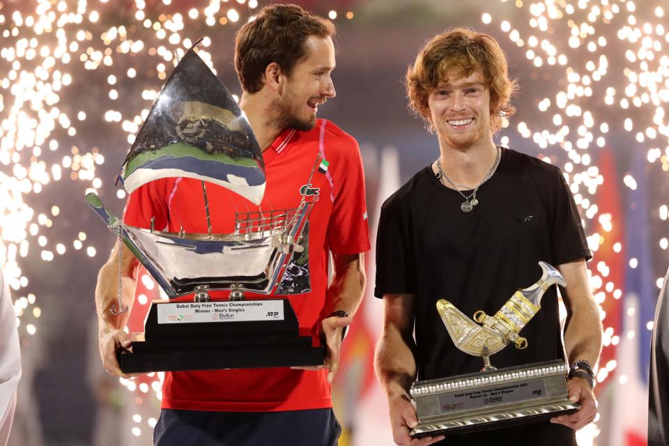 Daniil Medvedev (left) and Andrey Rublev pose with their trophies at the Dubai Tennis Championships in March 2023.