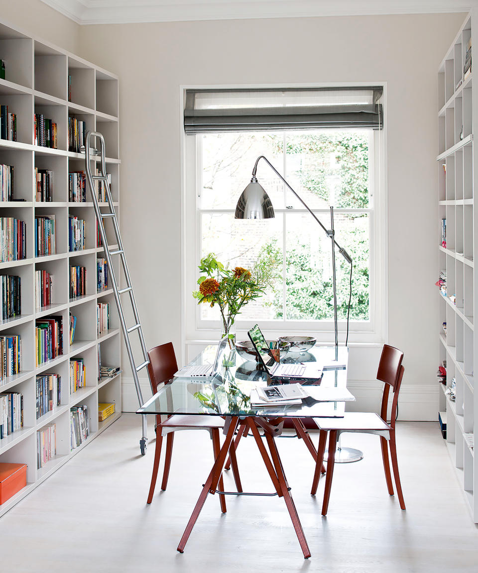 <p> One side of a double reception room in a classic Victorian house has been put to good use a family study.  </p> <p> The work table – a glass design, which doesn’t feel bulky in the space – has been placed in the middle of the room so that the two main walls could be lined with bookcases. Note the ingenious ladder on wheels, for accessing the high shelves. </p>