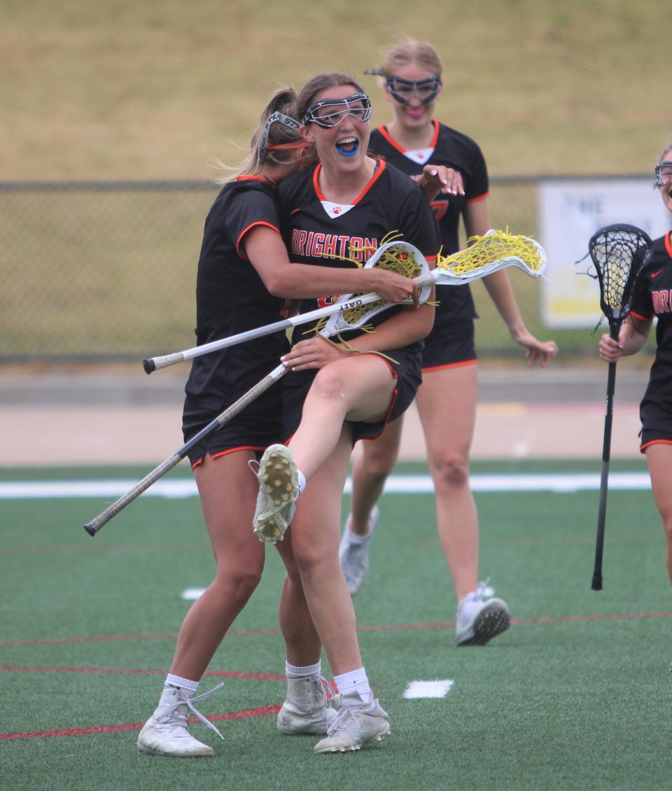 Brighton's Kaia Malachino (right) celebrates scoring the go-ahead goal during the state Division 1 girls lacrosse championship game Saturday, June 10, 2023 in Rockford.