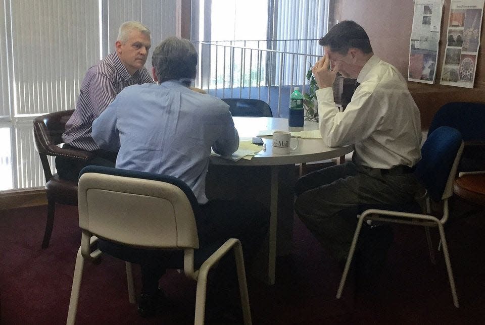 Register-Mail Editorial Board members Jay Redfern, left, Tom Martin, center, and Rob Buck, right, talk about which candidates to endorse prior to an election.