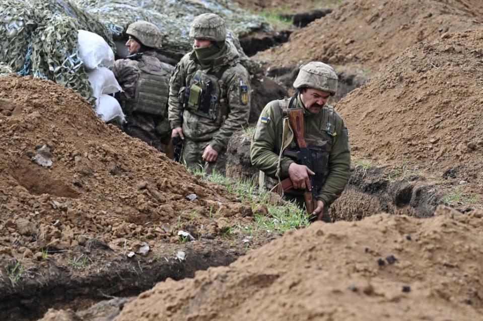 Ukrainian servicemen stand in a trench near their position near the town of Bakhmut, Donetsk region on April 8, 2023, amid the Russian invasion of Ukraine. (Photo by Genya Savilov/AFP via Getty Images)