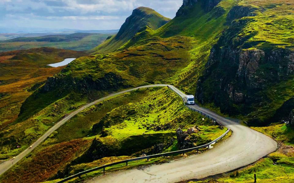 A caravan driving on a mountain road in Scotland