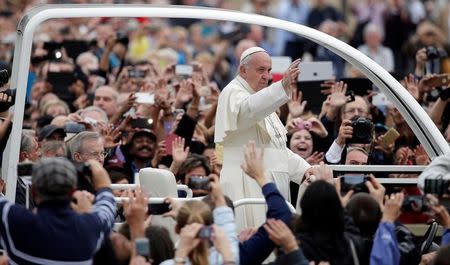 Pope Francis waves as he arrives to lead the general audience in Saint Peter's Square at the Vatican October 26, 2016. REUTERS/Max Rossi