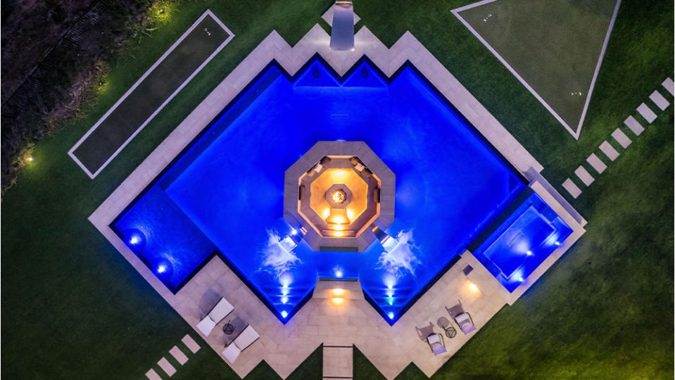 The pool has a 25-seat fire pit in the middle. - Credit: Joel Danto//Douglas Elliman Realty