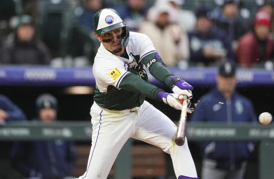 Colorado Rockies' Alan Trejo breaks his bat while grounding into a force play against Seattle Mariners starting pitcher Luis Castillo in the third inning of a baseball game Saturday, April 20, 2024, in Denver. (AP Photo/David Zalubowski)