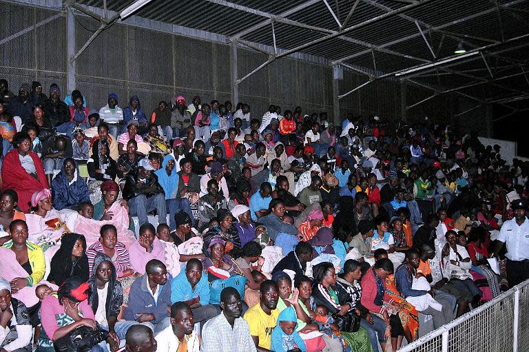 A group of 390 Malawians fleeing xenophobic violence in South Africa wait at Kamudzu stadium on April 20, 2015 in Blantyre, after being repatriated