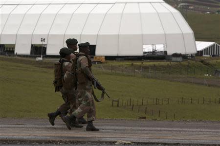 Soldiers patrol on the edge of the property of late former South African President Nelson Mandela in Qunu, Eastern Cape, December 12, 2013. REUTERS/Siegfried Modola