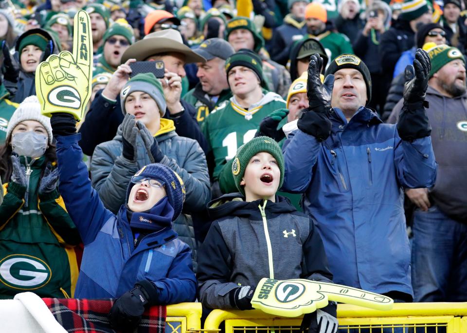 Green Bay Packers fans cheer as the team is announced before the game against the Los Angeles Rams on Nov. 28 at Lambeau Field.