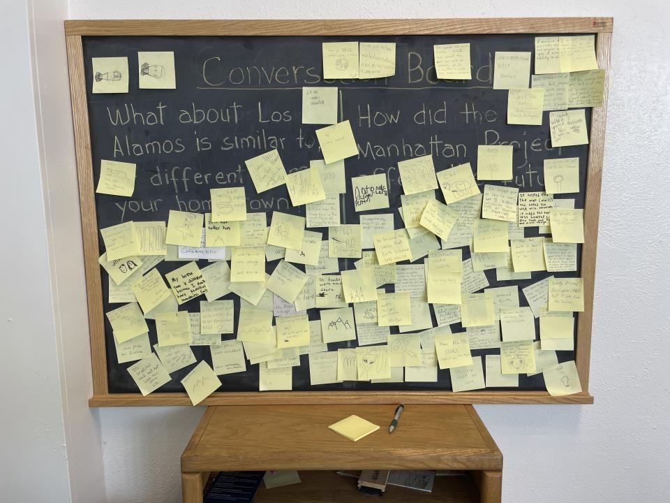 Messages left by visitors mark a chalk board at the Manhattan Project National Historical Park visitor center in Los Alamos, N.M., on Aug. 13, 2023. Almost overnight, Los Alamos was transformed to accommodate the scientists and soldiers who developed the world's first atomic bomb during World War II. The community is facing growing pains again, 80 years later, as it works to modernize the country's nuclear arsenal. (AP Photo/Susan Montoya Bryan)