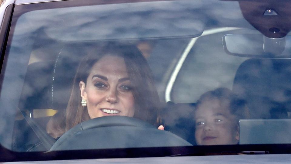 Kate Middleton driving a car with Princess Charlotte in the back seat