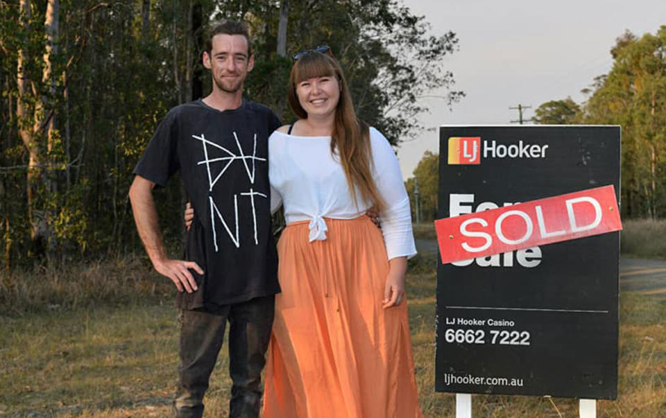 Hannah Lillywhite and Mat Haig pictured next to a sold sign after purchasing a property at West Bungawalbin.