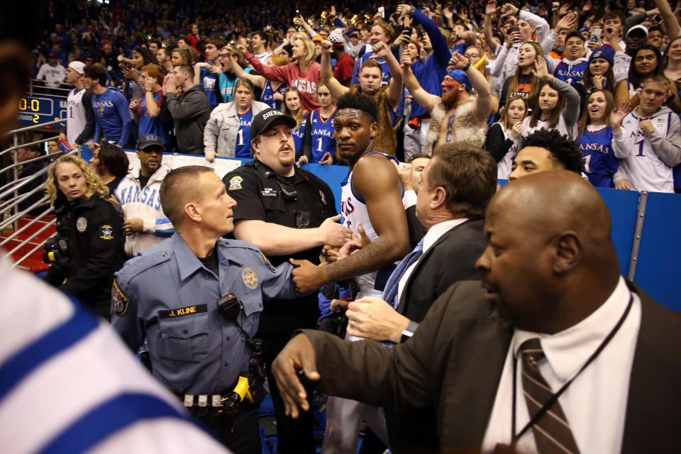 Kansas head coach Bill Self holds back Silvio De Sousa during a brawl against Kansas State. (Photo by Jamie Squire/Getty Images)