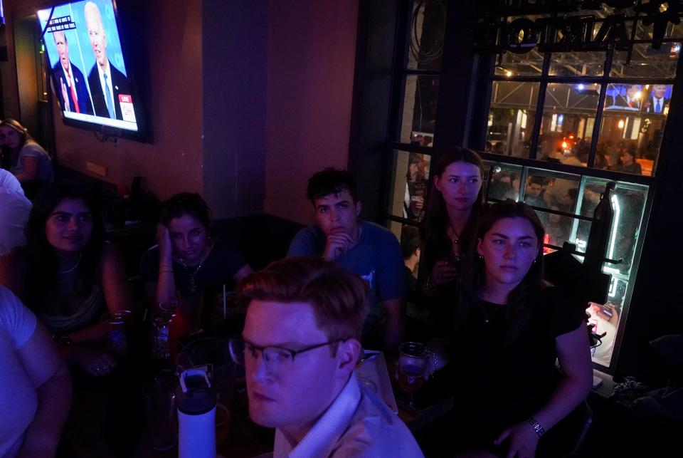 People attend a watch party for the first U.S. presidential debate hosted by CNN in Atlanta, at Union Pub on Capitol Hill in Washington, U.S., June 27, 2024. REUTERS/Nathan Howard