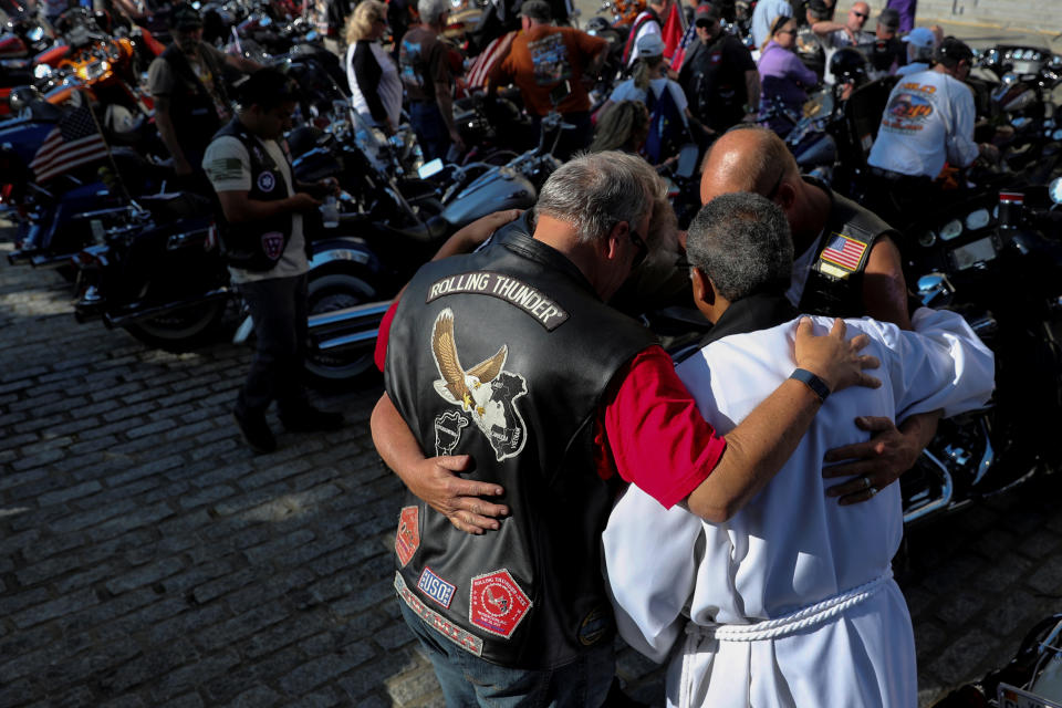 <p>Rolling Thunder motorcyclists, who ride annually on Memorial Day in support of U.S. military veterans, pray with an Episcopal priest as they have their bikes blessed during a brief service at the National Cathedral in Washington, May 25, 2018. (Photo: Jonathan Ernst/Reuters) </p>