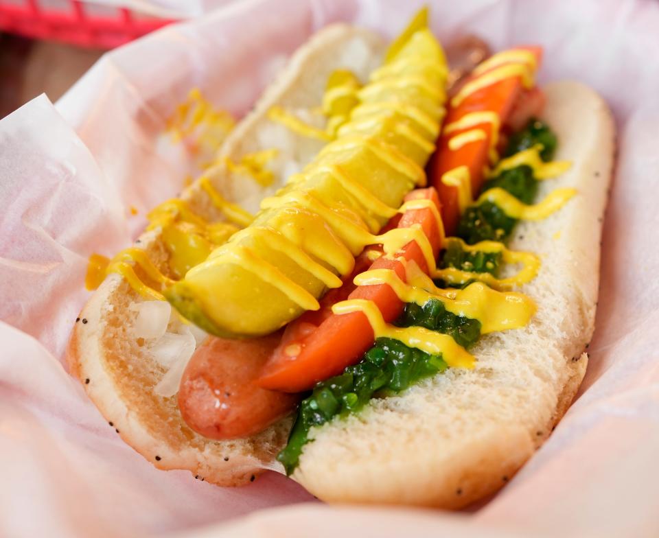 The Chicago Dog at Junkyard Dogs in Linworth is an all-beef hotdog topped with yellow mustard, relish, chopped onion, tomato, peppers and a dill pickle spear.