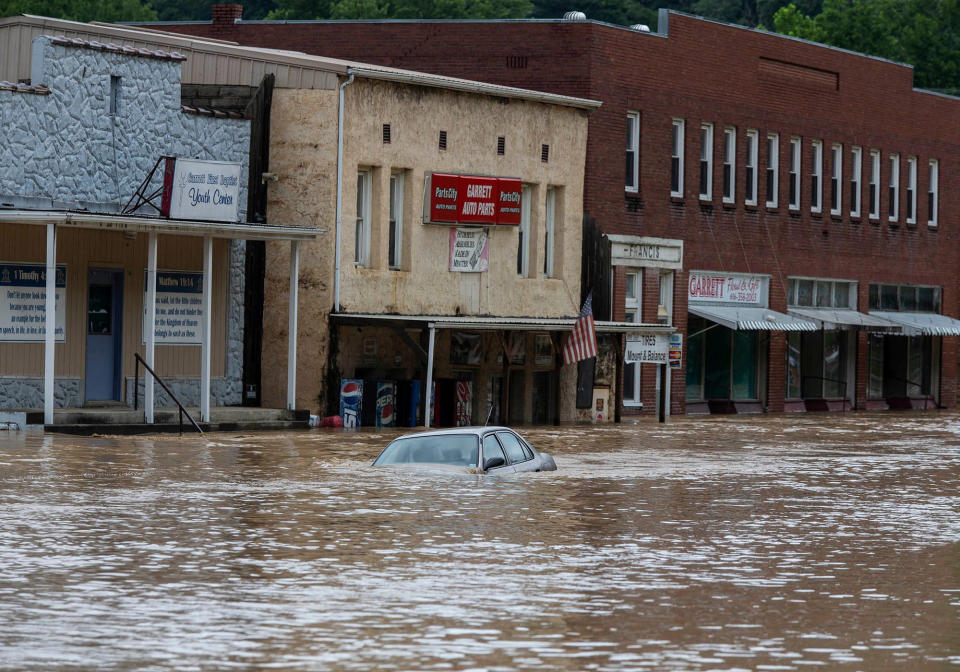 A car is submerged in floodwaters along Right Beaver Creek in Garrett, Ky., on Thursday. 