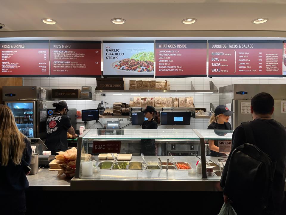 photo of the menu at the back of a chipotle in toronto