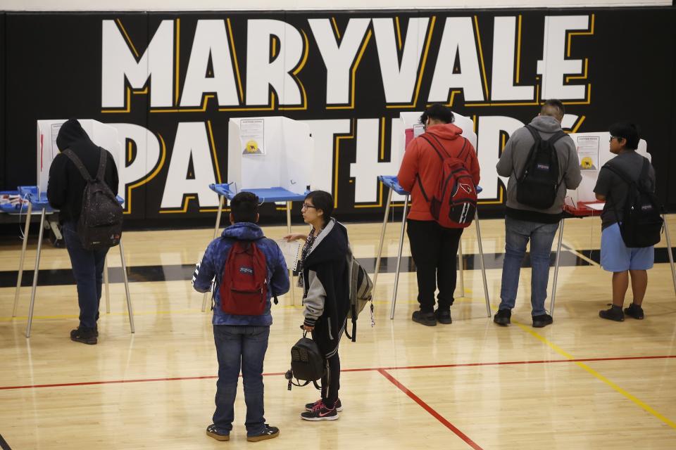 In this March 5, 2020, photo students participate in their own Democratic presidential preference election and voter registration drive at Maryvale High School in Phoenix. At the school hundreds of students who will turn 18 before Election Day were registered to vote. (AP Photo/Ross D. Franklin)