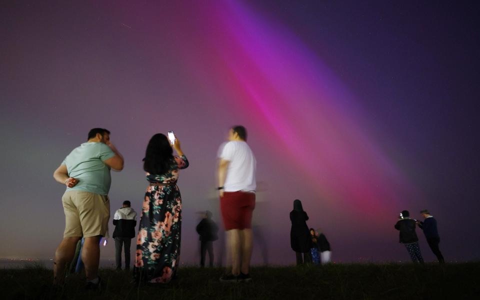 People gather at Crosby Beach to look at the Aurora Borealis, also known as the Northern Lights, in Crosby, Britain, 10 May 2024. The National Oceanic and Atmospheric Administration (NOAA) of America has warned that the strongest geomagnetic storm for 20 years is set to hit Earth, making the Aurora Borealis, or Northern Lights, visible at much lower geomagnetic latitudes than usual. Northern lights visible in Britain, Crosby, United Kingdom - 10 May 2024