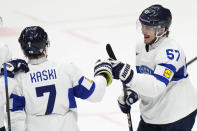 Finland's Arttu Hyry, right, celebrates with Finland's Oliwer Kaski after scoring his sides second goal during the preliminary round match between Finland and Norway at the Ice Hockey World Championships in Prague, Czech Republic, Monday, May 13, 2024. (AP Photo/Petr David Josek)