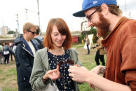 BERLIN, GERMANY - JULY 21: Attendees look at a pair of sunglasses from a "swap box," where visitors can take items in exchange for leaving others, at the second annual Hipster Olympics on July 21, 2012 in Berlin, Germany. With events such as the "Horn-Rimmed Glasses Throw," "Skinny Jeans Tug-O-War," "Vinyl Record Spinning Contest" and "Cloth Tote Sack Race," the Hipster Olympics both mocks and celebrates the Hipster subculture, which some critics claim could never be accurately defined and others that it never existed in the first place. The imprecise nature of determining what makes one a member means that the symptomatic elements of adherants to the group vary in each country, but the archetype of the version in Berlin, one of the more popular locations for those following its lifestyle, along with London and Brooklyn, includes a penchant for canvas tote bags, the carbonated yerba mate drink Club Mate, analogue film cameras, asymmetrical haircuts, 80s neon fashion, and, allegedly, a heavy dose of irony. To some in Berlin, members of the hipster "movement" have replaced a former unwanted identity in gentrifying neighborhoods, the Yuppie, for targets of criticism, as landlords raise rents in the areas to which they relocate, particularly the up-and-coming neighborhood of Neukoelln. (Photo by Adam Berry/Getty Images)