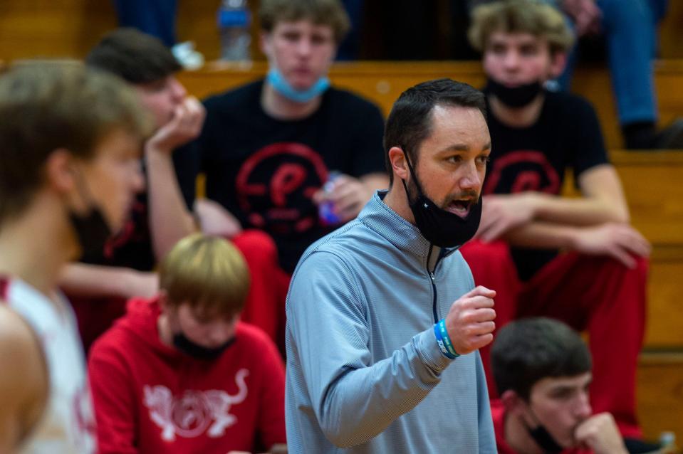 Pekin varsity boys basketball head coach Jeremy Crouch directs players during a home game against Washington High on Friday, Dec. 17, 2021.