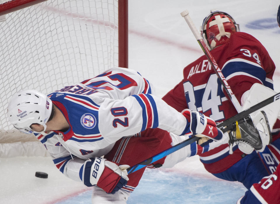 Montreal Canadiens goaltender Jake Allen is scored on by New York Rangers' Chris Kreider (20) during the second period of an NHL hockey game Saturday, Oct. 16, 2021, in Montreal. (Graham Hughes/The Canadian Press via AP)