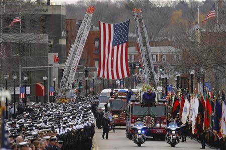 A fire engine carries the body of Boston Fire Department Lieutenant Edward Walsh to his funeral at Saint Patrick's Church in Watertown, Massachusetts April 2, 2014. REUTERS/Brian Snyder