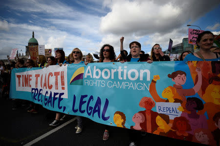 Demonstrators hold posters as they march for more liberal Irish abortion laws, in Dublin, Ireland September 30, 2017. REUTERS/Clodagh Kilcoyne