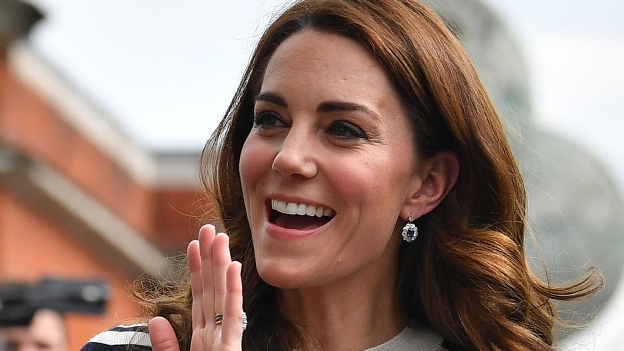 Kate Middleton waving in a striped top