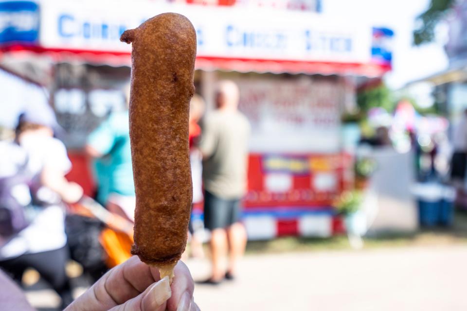 A corn dog is one of the dishes Ian and Jess Robertson tried during Day 1 of the Iowa State Fair.